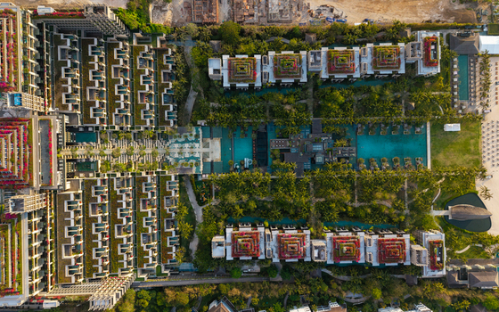 Aerial view of The Apurva Kempinski Bali featuring lush gardens expansive swimming pools and tiered architecture nestled along the coastline in Kecamatan Kuta Selatan Bali Indonesia. Aerial view of The Apurva Kempinski Bali featuring lush gardens expansive swimming pools and tiered architecture nestled along the coastline in Kecamatan Kuta Selatan Bali Indonesia.