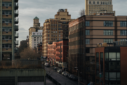 View of the Brooklyn streetscape featuring a mix of historic brick buildings and modern architecture under an overcast sky in Kings County New York United States.