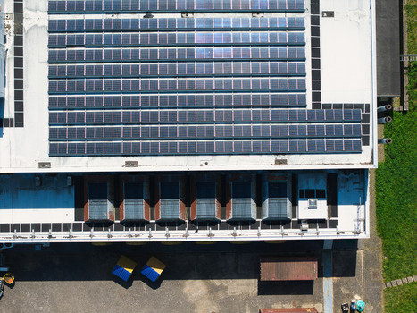 Aerial view of a data centre roof featuring rows of solar panels and industrial ventilation units in Wellingborough England United Kingdom. Aerial view of a data centre roof featuring rows of solar panels and industrial ventilation units in Wellingborough England United Kingdom.