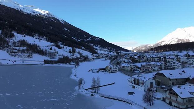 Aerial view of Graun im Vinschgau village and frozen lake Italy. Aerial view of Graun im Vinschgau village and frozen lake Italy.