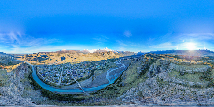 Aerial view of El Chalten town nestled in the Patagonia valley with the Fitz Roy mountain range in the background and a winding river El Chalten Santa Cruz Argentina. Aerial view of El Chalten town nestled in the Patagonia valley with the Fitz Roy mountain range in the background and a winding river El Chalten Santa Cruz Argentina.