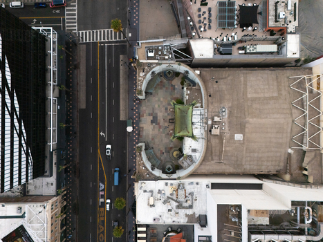 Aerial view of the Hollywood Walk of Fame featuring the iconic Chinese Theatre courtyard surrounded by urban streets and city buildings in Los Angeles California United States.