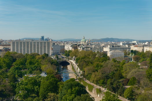 Wien Austria 25 April 2026 Aerial view of Stadtpark with the Wien River flowing through lush green trees historic architecture and the Karlskirche dome under a clear blue sky. Wien Austria 25 April 2026 Aerial view of Stadtpark with the Wien River flowing through lush green trees historic architecture and the Karlskirche dome under a clear blue sky.
