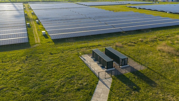 Aerial view of Solar park Delfzijl featuring rows of photovoltaic panels and power inverters on green fields in Farmsum Groningen Netherlands. Aerial view of Solar park Delfzijl featuring rows of photovoltaic panels and power inverters on green fields in Farmsum Groningen Netherlands.