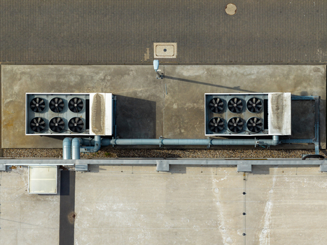 Aerial view of a cooling system with industrial fans installed on the flat roof of a logistics center in Warsaw Masovian Voivodeship Poland. Aerial view of a cooling system with industrial fans installed on the flat roof of a logistics center in Warsaw Masovian Voivodeship Poland.