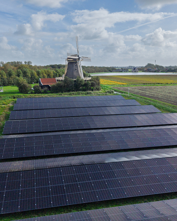 Aerial view of Molen De Hoop windmill situated next to a large solar panel farm in the rural landscape of t Zand North Holland Netherlands. Aerial view of Molen De Hoop windmill situated next to a large solar panel farm in the rural landscape of t Zand North Holland Netherlands.
