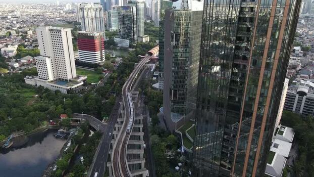 Aerial view of a train on elevated tracks in Indonesia. Aerial view of a train on elevated tracks in Indonesia.