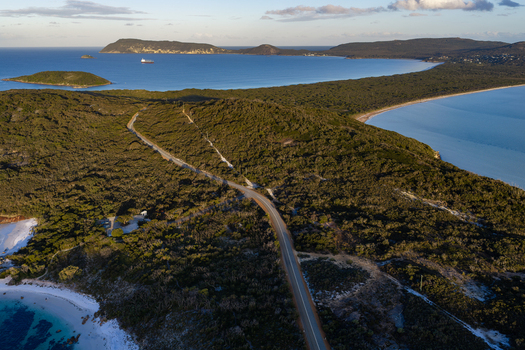 Aerial view of Camp Quaranup and the coastal landscape featuring dense vegetation and a winding road in Vancouver Peninsula Western Australia Australia. Aerial view of Camp Quaranup and the coastal landscape featuring dense vegetation and a winding road in Vancouver Peninsula Western Australia Australia.