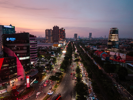 Aerial view of the urban skyline and busy traffic on a main road at twilight in Surabaya East Java Indonesia. Aerial view of the urban skyline and busy traffic on a main road at twilight in Surabaya East Java Indonesia.