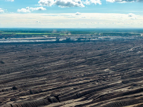 Aerial view of Tagebau Welzow Sud brown coal open pit mine showing vast excavated earth layers industrial machinery and distant landscape in Spremberg Brandenburg Germany. Aerial view of Tagebau Welzow Sud brown coal open pit mine showing vast excavated earth layers industrial machinery and distant landscape in Spremberg Brandenburg Germany.
