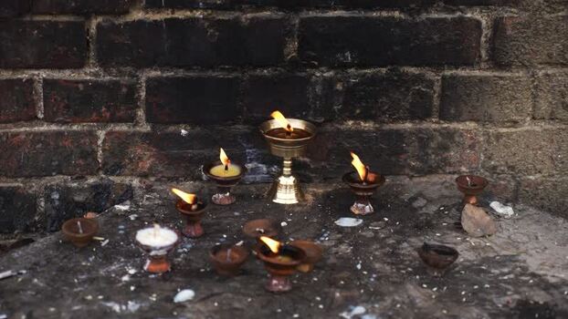 View of burning oil lamps at the sacred site of Lumbini Nepal.