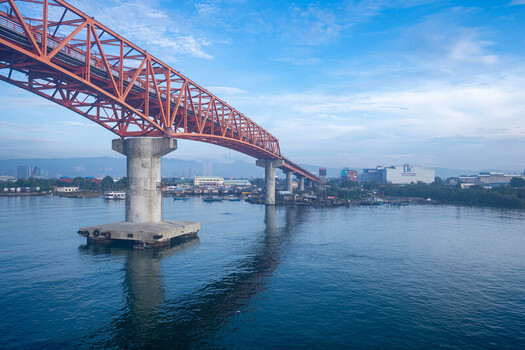 Cebu Philippines 23 September 2026 View of the Cebu Cordova Link Expressway bridge spanning over the calm blue waters of the Mactan Channel with coastal buildings under a bright sky. Cebu Philippines 23 September 2026 View of the Cebu Cordova Link Expressway bridge spanning over the calm blue waters of the Mactan Channel with coastal buildings under a bright sky.