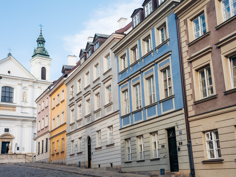 View of the colorful historic buildings and the church tower in Warsaw Old Town Warsaw Masovian Voivodeship Poland. View of the colorful historic buildings and the church tower in Warsaw Old Town Warsaw Masovian Voivodeship Poland.