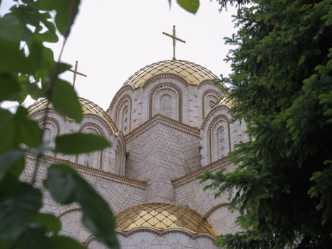 View of Church of Saints Constantine and Helena with golden domes and intricate stone facade framed by green foliage in Shkupi Qyteti i Shkupit North Macedonia. View of Church of Saints Constantine and Helena with golden domes and intricate stone facade framed by green foliage in Shkupi Qyteti i Shkupit North Macedonia.