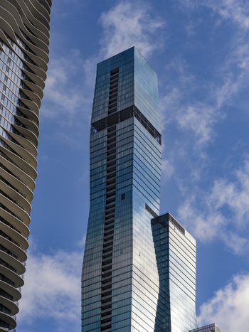 Chicago United States 15 September 2025 View of the St. Regis Chicago skyscraper with its undulating glass facade and the Aqua building under a blue sky with light clouds.