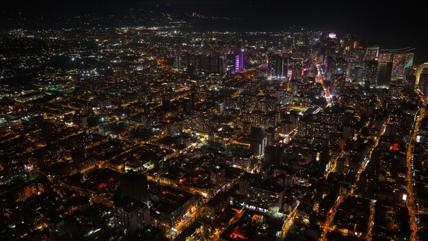 Batumi Georgia 17 September 2026 Aerial view of the illuminated cityscape of Batumi at night featuring dense urban blocks glowing street lights and high rise buildings.