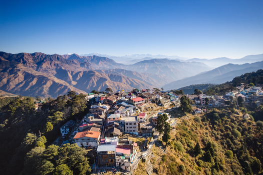 Aerial view of the colorful buildings and rooftops of Chakrata hill station nestled on a mountain ridge under a clear blue sky in Chakrata Uttarakhand India. Aerial view of the colorful buildings and rooftops of Chakrata hill station nestled on a mountain ridge under a clear blue sky in Chakrata Uttarakhand India.