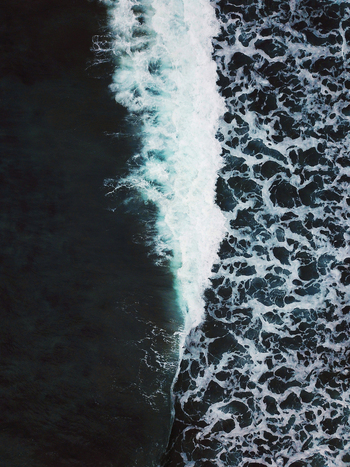 Aerial view of waves crashing in the Atlantic ocean at Saksun beach Streymoy Faroe Islands Denmark.