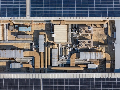 Aerial view of solar panels and industrial HVAC ventilation systems on a flat rooftop in Cascais Lisboa Portugal. Aerial view of solar panels and industrial HVAC ventilation systems on a flat rooftop in Cascais Lisboa Portugal.