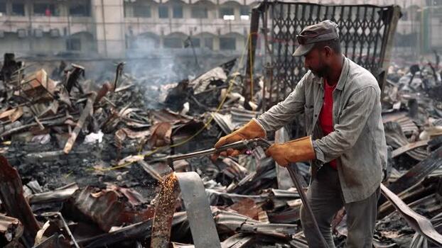View of a worker cutting metal debris in Dhaka Bangladesh. View of a worker cutting metal debris in Dhaka Bangladesh.