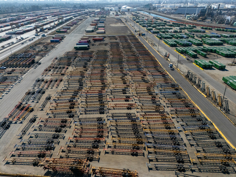 Aerial view of a vast storage yard filled with rows of container chassis and shipping containers in an industrial area in Carson California United States.