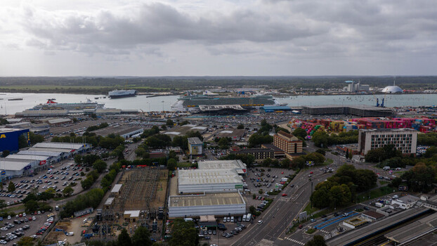 Aerial view of the port of Southampton with cruise ships docked at the terminal industrial buildings parking lots and roads in Southampton England United Kingdom. Aerial view of the port of Southampton with cruise ships docked at the terminal industrial buildings parking lots and roads in Southampton England United Kingdom.
