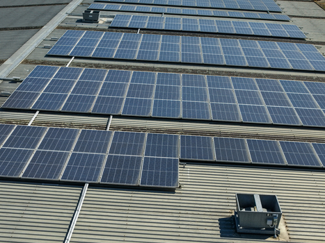 Aerial view of solar panels installed on the corrugated metal roof of a factory building in Kilsyth Victoria Australia. Aerial view of solar panels installed on the corrugated metal roof of a factory building in Kilsyth Victoria Australia.
