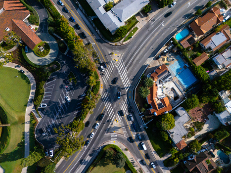 Aerial view of Wilshire Country Club and the surrounding intersection with residential streets lush trees and swimming pools in Los Angeles California United States. Aerial view of Wilshire Country Club and the surrounding intersection with residential streets lush trees and swimming pools in Los Angeles California United States.