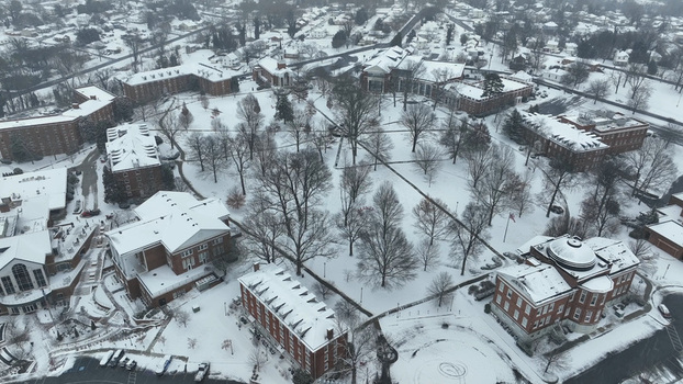 Aerial view of the University of Lynchburg campus covered in snow featuring red brick buildings bare trees and snow covered pathways in Lynchburg Virginia United States.