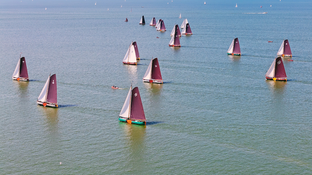 Aerial view of traditional Dutch sailing boats sailing on the IJsselmeer in Hindeloopen Friesland Netherlands.