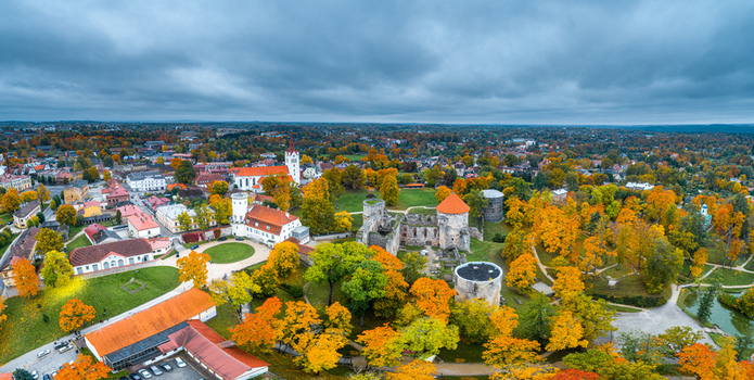 Aerial view of Cesis Castle surrounded by vibrant autumn foliage and historic town buildings in Cesis Cesis Municipality Latvia. Aerial view of Cesis Castle surrounded by vibrant autumn foliage and historic town buildings in Cesis Cesis Municipality Latvia.