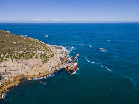 Aerial view of shipwreck crane barge is off the coast of Sandy Bay Cape Town Western Cape Province South Africa.
