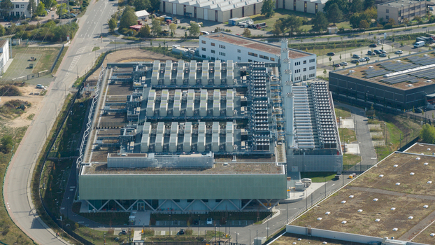 Aerial view of a modern industrial power plant facility featuring numerous rooftop cooling units and a tall chimney situated in an industrial park in Dietzenbach Hessen Germany. Aerial view of a modern industrial power plant facility featuring numerous rooftop cooling units and a tall chimney situated in an industrial park in Dietzenbach Hessen Germany.