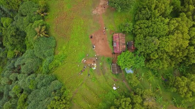 Aerial view of Bukit Pengilon with people near small huts Indonesia.