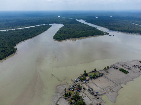 Aerial view of Kalabagi village situated along a winding river near the dense mangrove forests of the Sundarbans Khulna District Khulna Division Bangladesh.