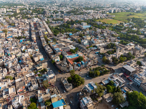 Aerial view of the historic city of Udaipur featuring dense urban architecture narrow streets and traditional rooftops in Udaipur Rajasthan India.