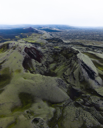 Aerial view of moss covered volcanic landscape stretching into the distance under a cloudy sky Lakagigar Iceland. Aerial view of moss covered volcanic landscape stretching into the distance under a cloudy sky Lakagigar Iceland.
