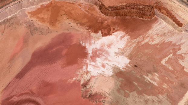 Aerial view of industrial salt mine patterns with red earth white salt deposits and textured terrain in Kalbarri Western Australia Australia. Aerial view of industrial salt mine patterns with red earth white salt deposits and textured terrain in Kalbarri Western Australia Australia.