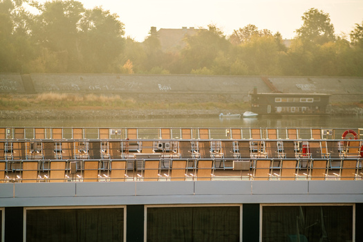 View of rows of sun loungers on the deck of a river cruise ship docked along the Danube river in Novi Sad Vojvodina Serbia. View of rows of sun loungers on the deck of a river cruise ship docked along the Danube river in Novi Sad Vojvodina Serbia.