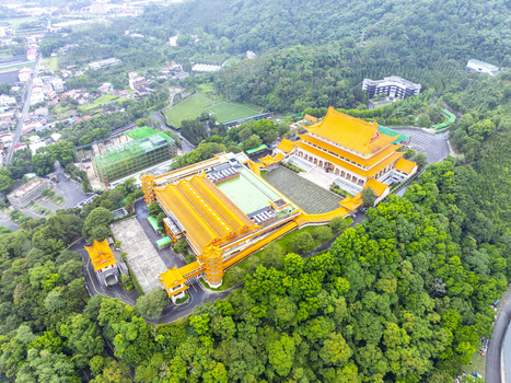 Aerial view of Chung Tai Chan Monastery with its distinctive golden roofs and traditional architecture surrounded by lush green forests in Puli Township Nantou County Taiwan. Aerial view of Chung Tai Chan Monastery with its distinctive golden roofs and traditional architecture surrounded by lush green forests in Puli Township Nantou County Taiwan.