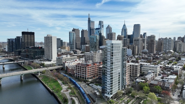 Aerial view of a vibrant city skyline reflecting the clear sky juxtaposed with the Schuylkill River and the urban landscape Philadelphia Pennsylvania United States.