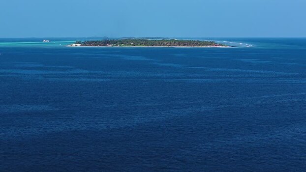 Aerial view of a tropical island in the ocean Maldives. Aerial view of a tropical island in the ocean Maldives.