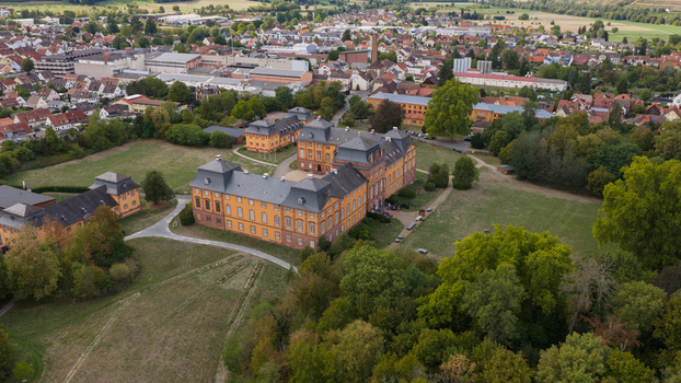 Aerial view of Chateauform Schloss Lowenstein surrounded by lush green parkland and the town of Kleinheubach in Bayern Germany. Aerial view of Chateauform Schloss Lowenstein surrounded by lush green parkland and the town of Kleinheubach in Bayern Germany.