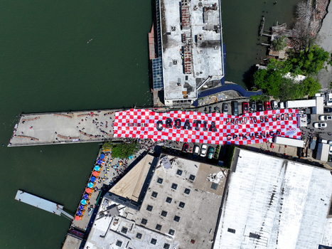 Long Island City United States 13 June 2026 Aerial view of a massive red and white checkered Croatian flag banner displayed on a pier during a FIFA World Cup fan celebration.