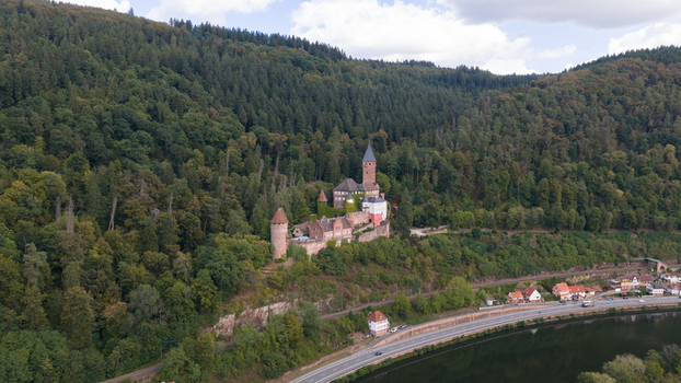 Aerial view of Zwingenberg Castle nestled on a forested hillside overlooking the Neckar river and a road in Zwingenberg Baden Wurttemberg Germany. Aerial view of Zwingenberg Castle nestled on a forested hillside overlooking the Neckar river and a road in Zwingenberg Baden Wurttemberg Germany.