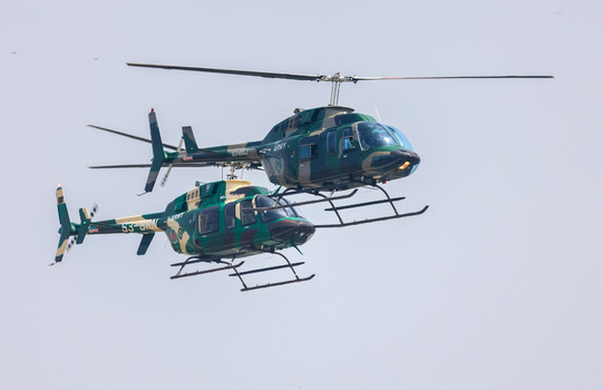 Dhaka Bangladesh 25 March 2026 View of two military helicopters soaring through the expansive sky their camouflage paint blending with the heavens.