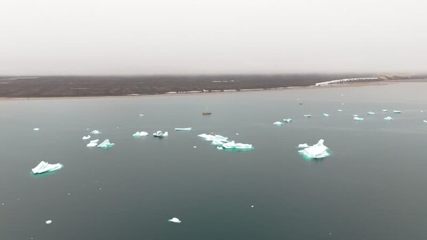 Aerial view of icebergs floating in the sea near Disko Island Greenland. Aerial view of icebergs floating in the sea near Disko Island Greenland.