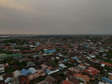 Aerial view of the dense residential rooftops and urban landscape of Banjarmasin City South Kalimantan Indonesia. Aerial view of the dense residential rooftops and urban landscape of Banjarmasin City South Kalimantan Indonesia.