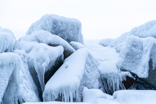 View of ice covered rocks and frozen sea spray on the breakwater near the Molenfeuer Sassnitz in Sassnitz Mecklenburg Vorpommern Germany.