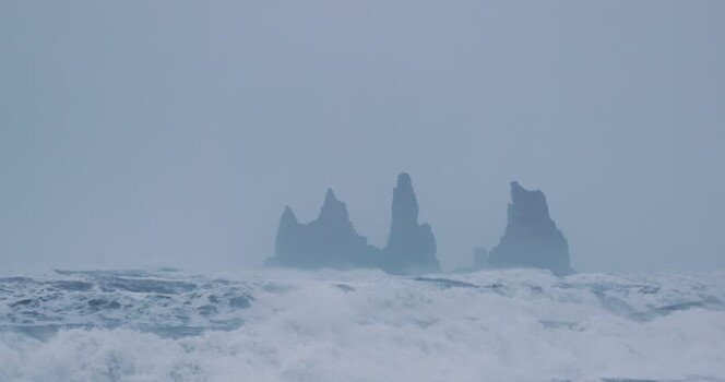 View of Reynisdrangar sea stacks in the Atlantic Ocean Iceland. View of Reynisdrangar sea stacks in the Atlantic Ocean Iceland.